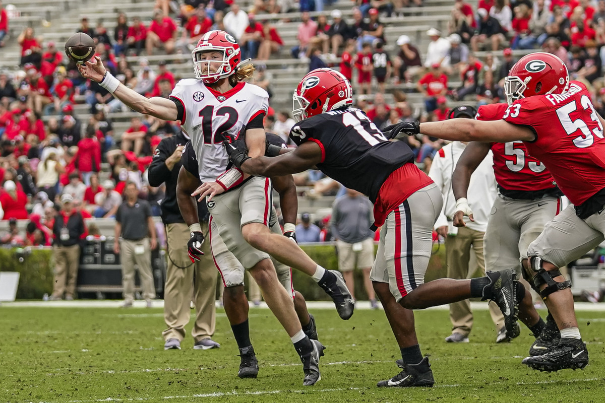 Apr 16, 2022; Athens, Georgia, USA; Georgia Bulldogs quarterback Brock Vandagriff (12) passes under pressure from defensive lineman Mykel Williams (13) during the Georgia Bulldogs Spring Game at Sanford Stadium. Credit: Dale Zanine-USA TODAY Sports